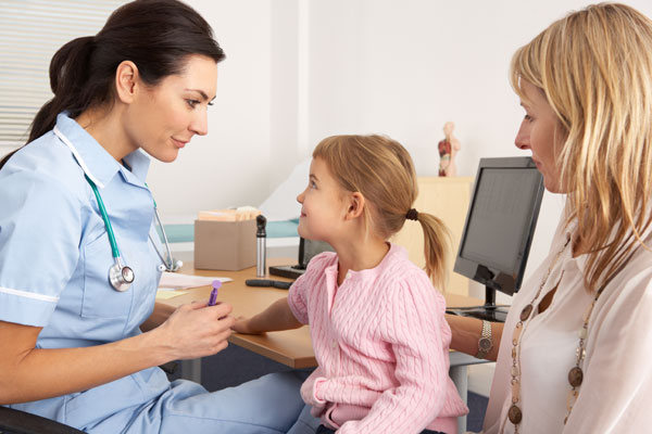 Young family speaking to nurse