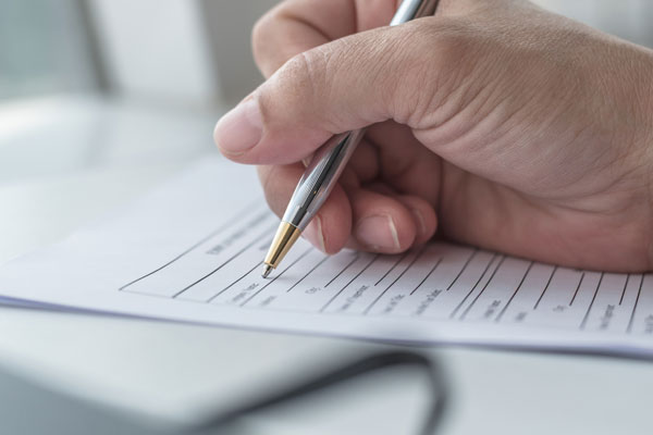 Man filling in patient registration form